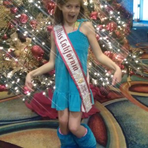 Miss California  posing in front of the Christmas Tree
