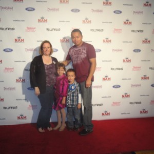 Miss Arizona Gabriela Bustillos and family in front of the red carpet backdrop