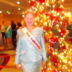 Illinois State Ambassador (Pre-Teen) Bridget Dunn in front of a festive Christmas tree!