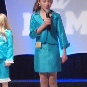 Jr. Pre Teen Sienna Larson from nevada in the red carpet room w a nam backdrop. 