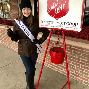 Anna ringing the bell for the Salvation Army. 