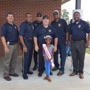 National American Miss Alabama Princess, Jaidyn McDuffie, volunteering with the local police department during National Night Out. 